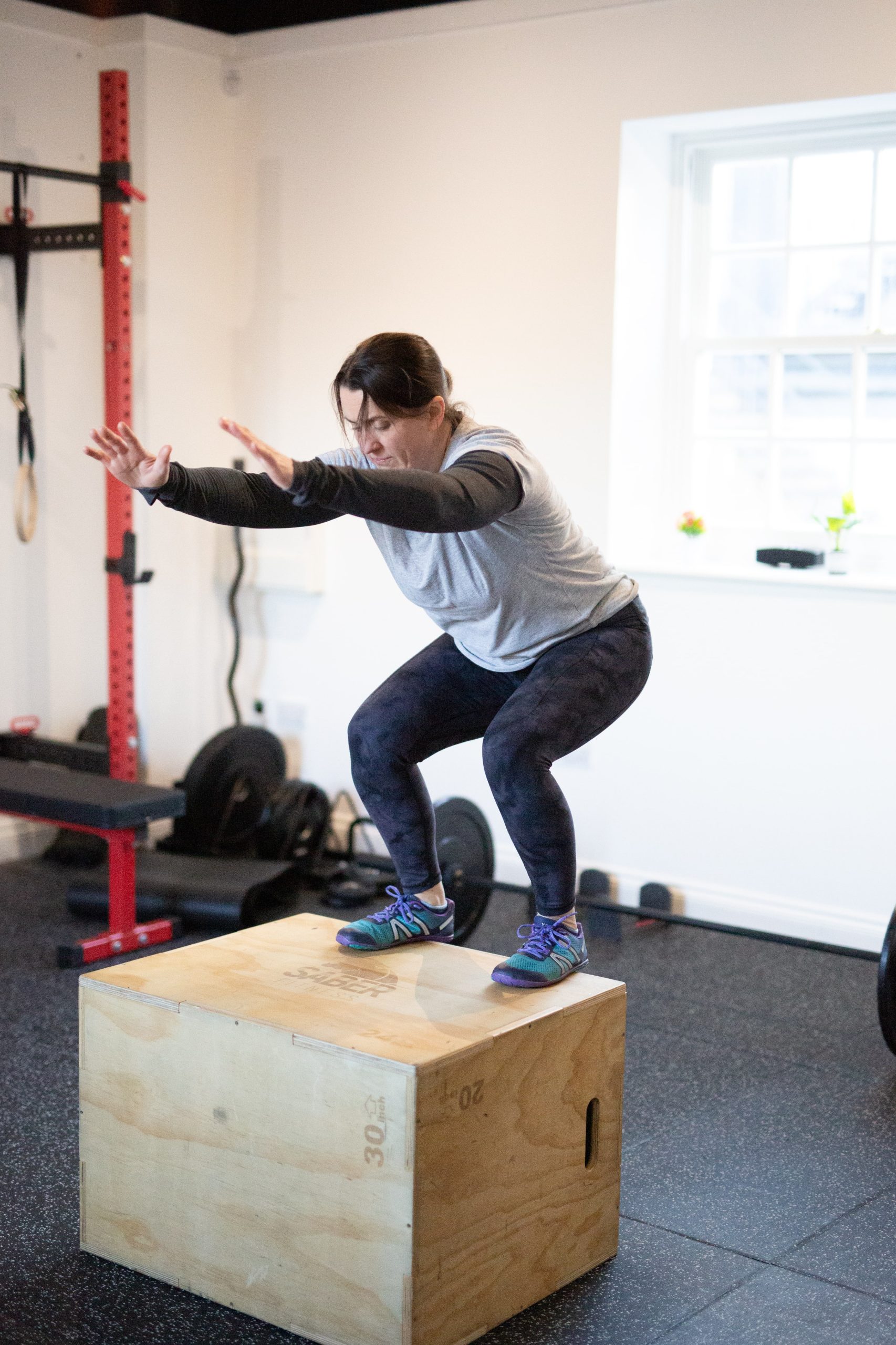 Squats on wooden box fitness